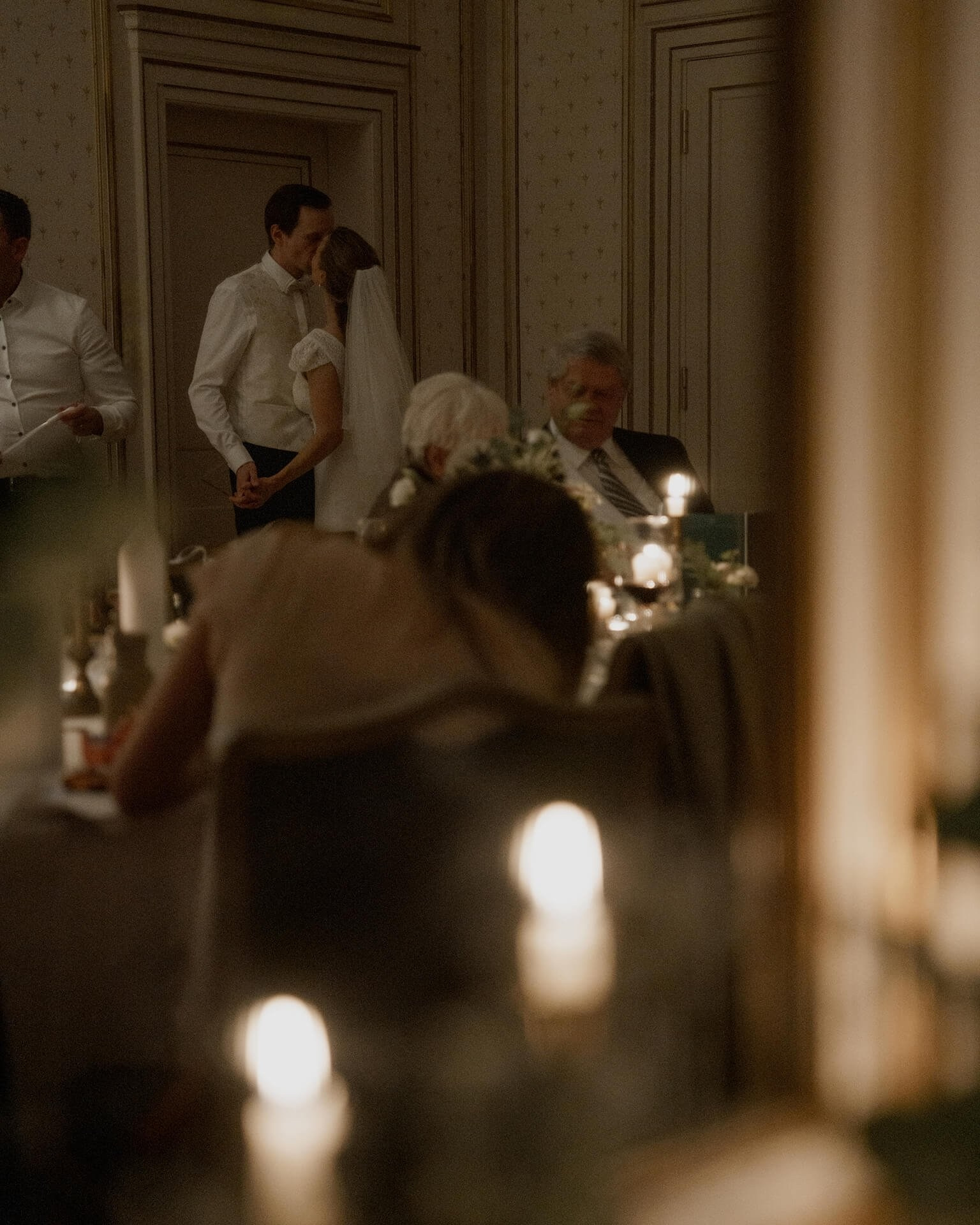 Couple embracing indoors, candlelit reception at Falkenstein Grand