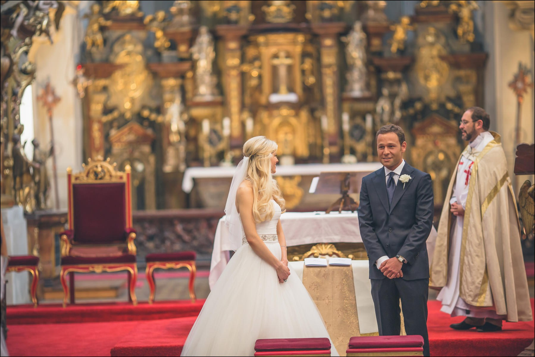 Happy bride and groom at altar during Prague church wedding ceremony
