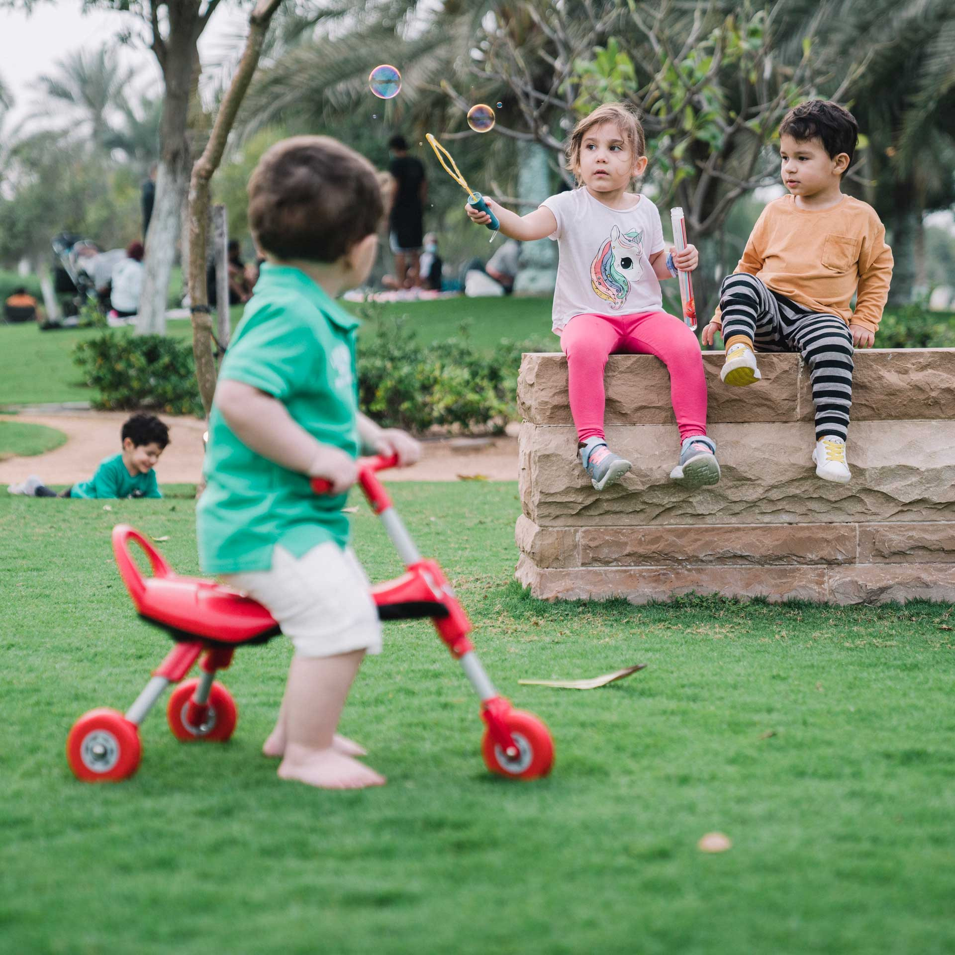 three kids playing in a park