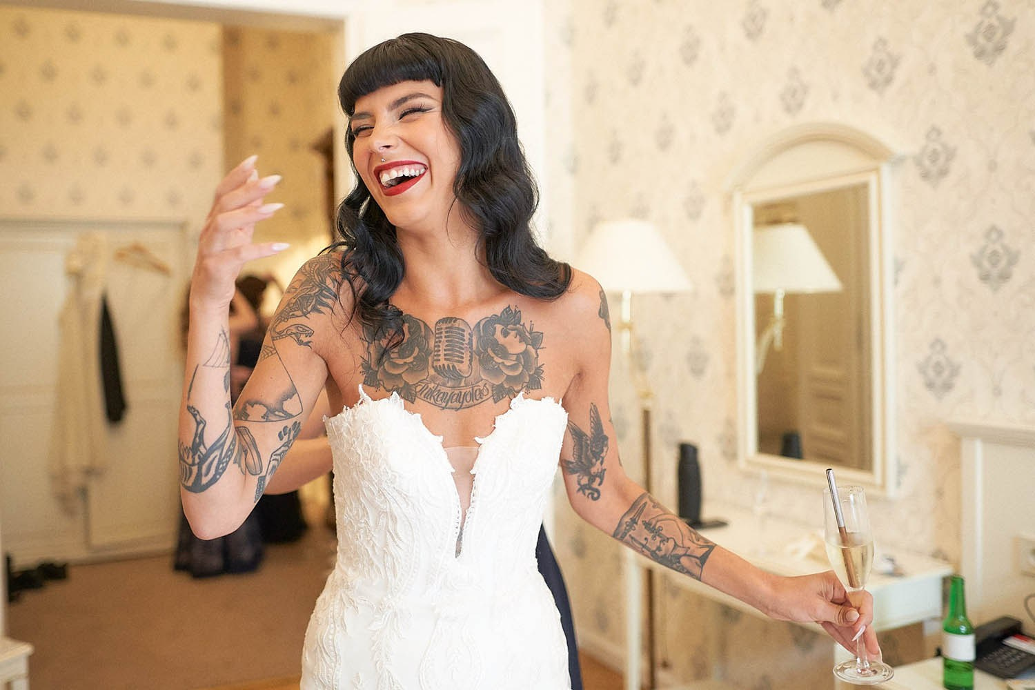 Emotional bride smiling in awe after donning the wedding gown.