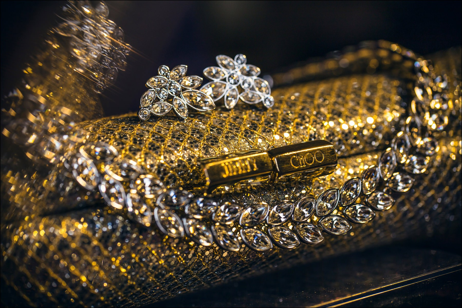 Jimmy Choo bridal purse and earrings in golden tones during luxury wedding preparations in Prague