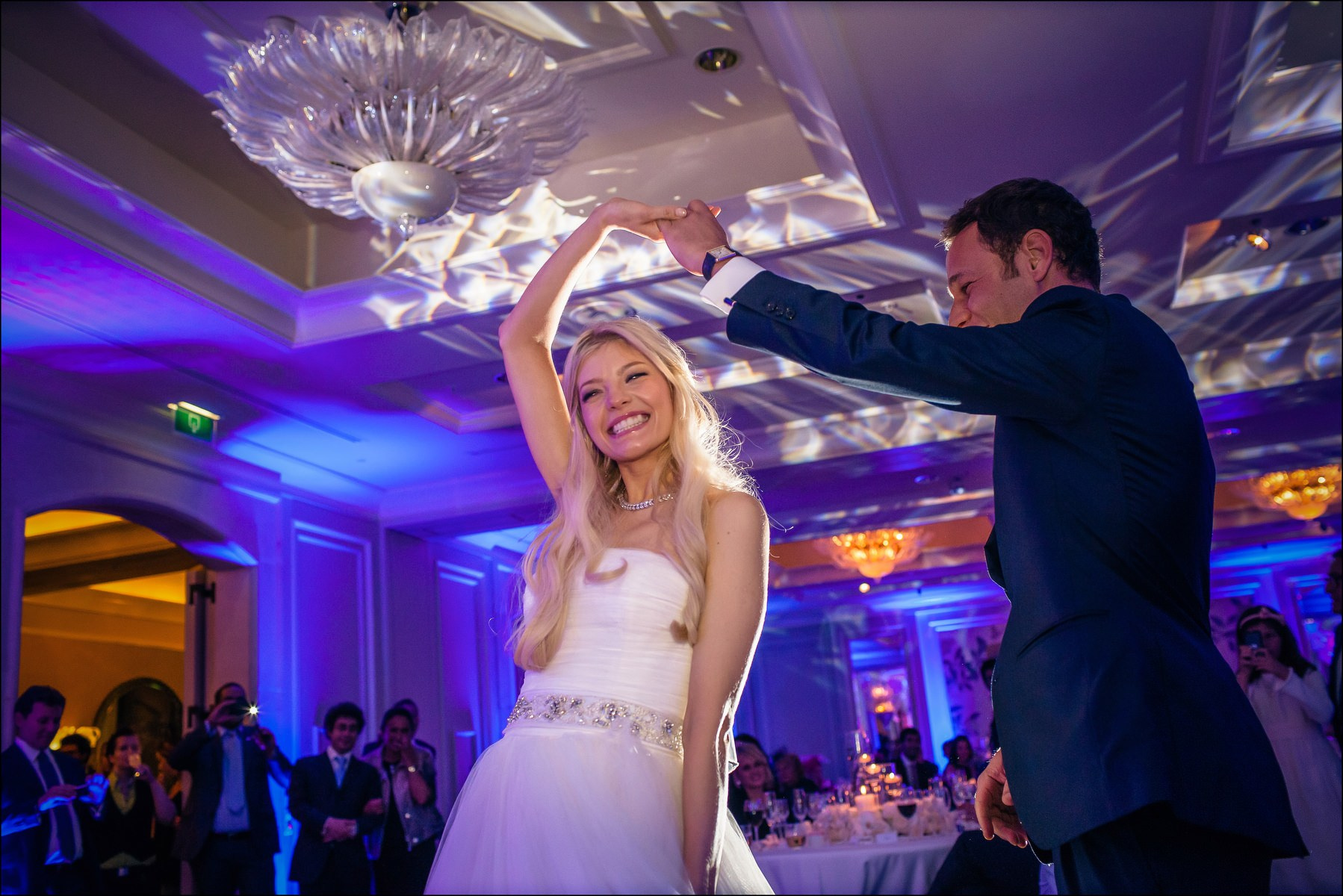 Groom spinning bride during first dance luxury reception Prague