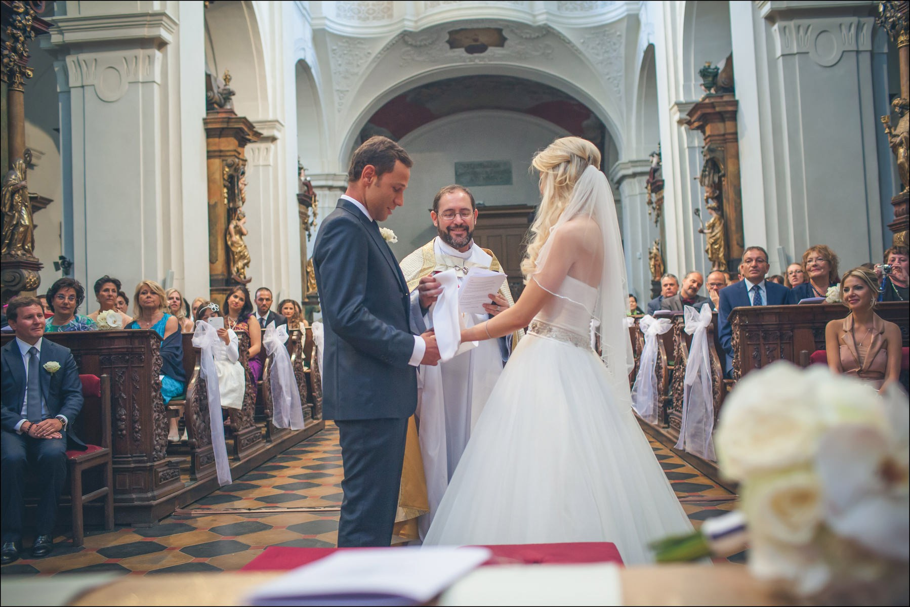 Excited bride Julia moments before first kiss at Prague wedding altar