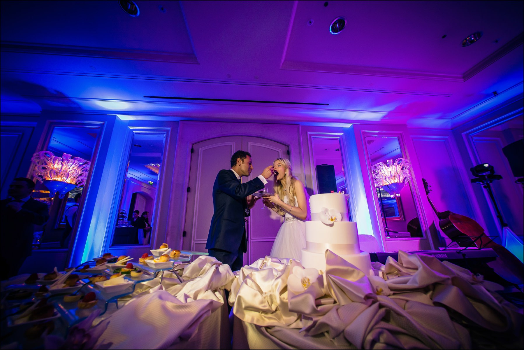 Groom feeding bride cake during reception Four Seasons Prague