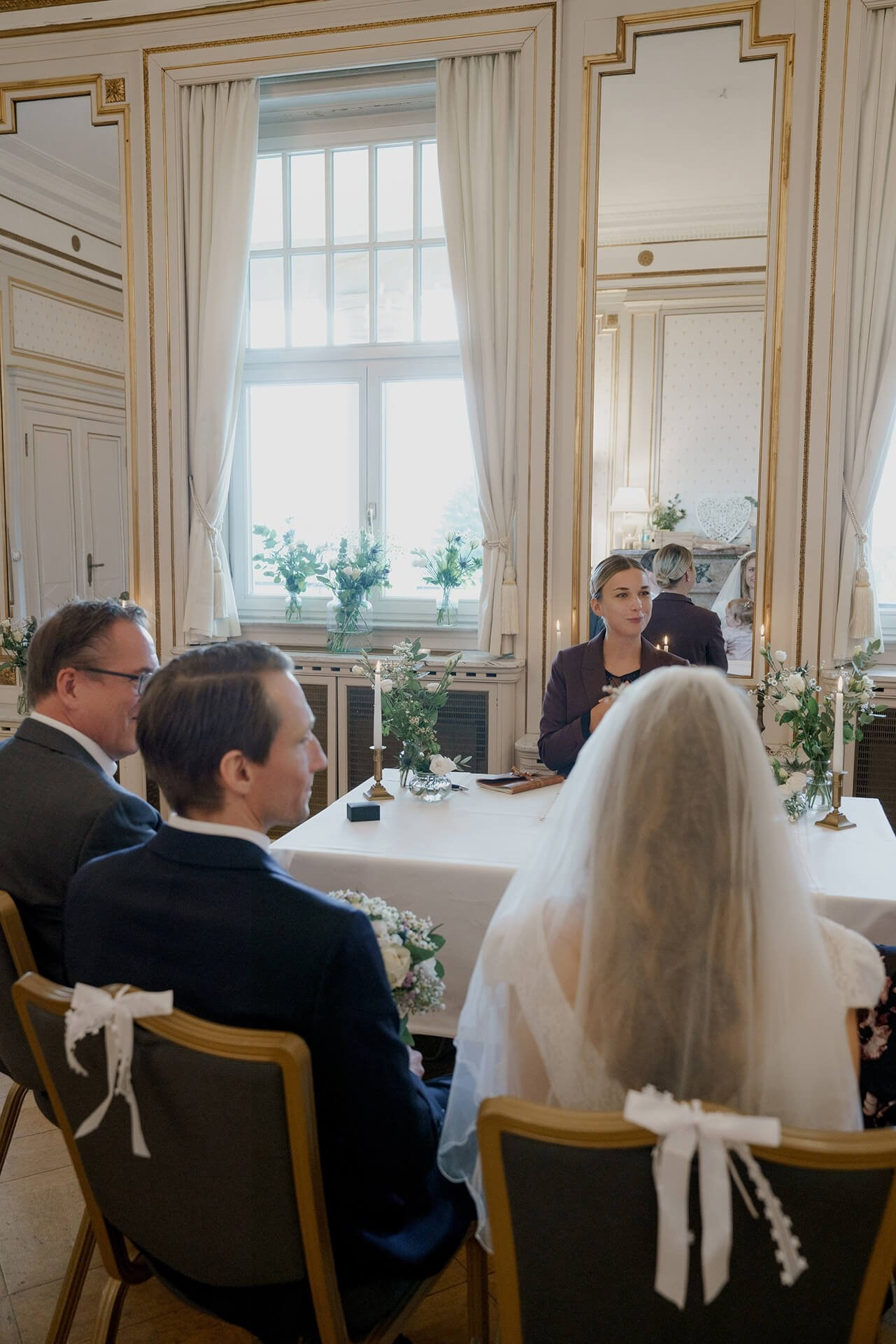 Civil wedding ceremony indoors, couple seated at Falkenstein Grand