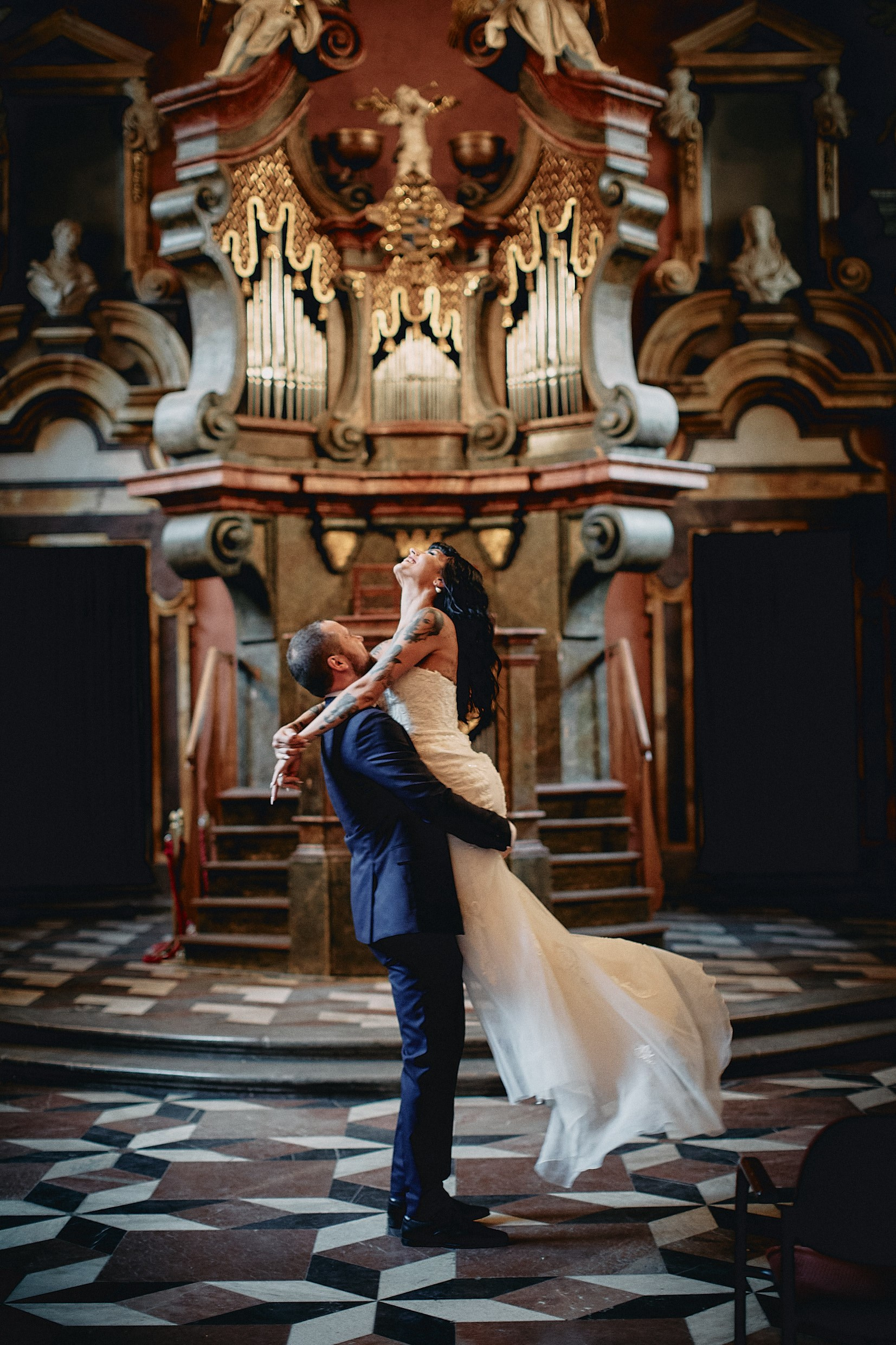 Radiant bride dancing joyfully with groom in historic chapel.