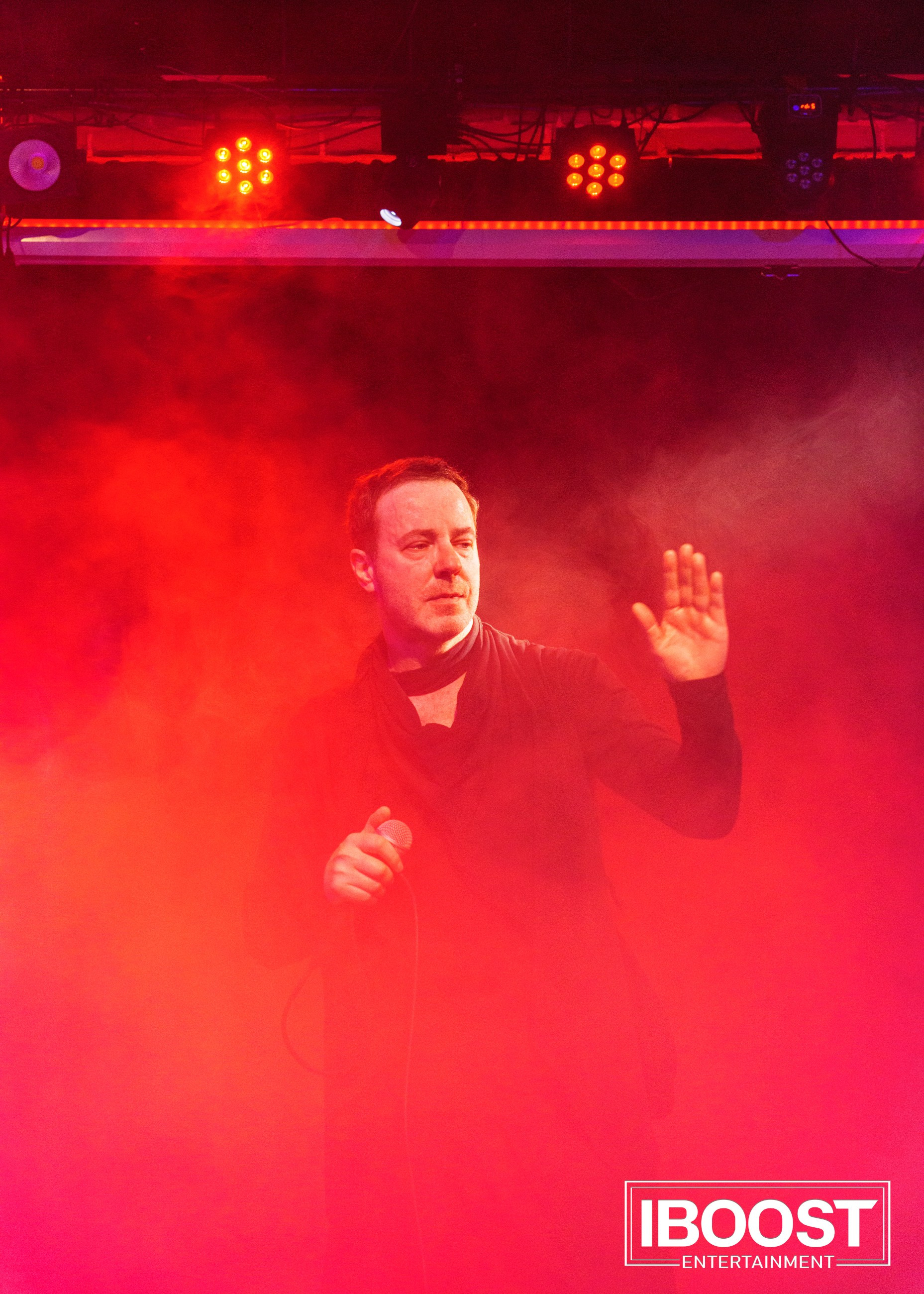 Vocalist Krasovitsky on stage in red light and haze during the Animal JazZ concert in Sofia.