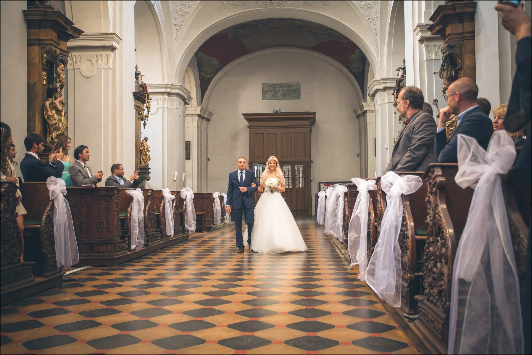 Father walking bride Julia down aisle at St. Thomas Church Prague wedding