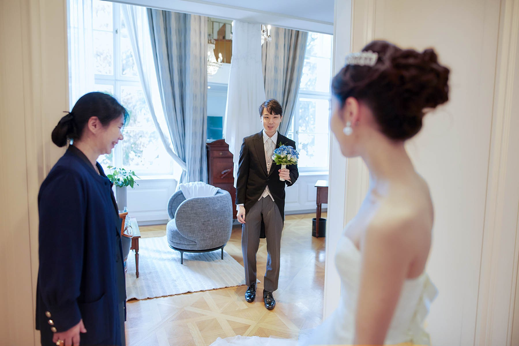 Katsuya admires his young bride as his mother stands nearby.