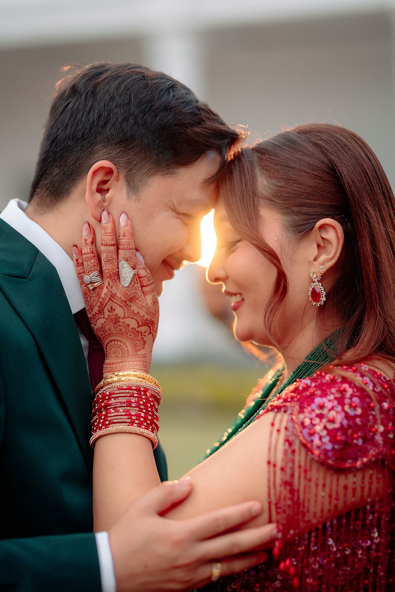 A newlywed Nepali couple gently touching foreheads during a sunset wedding photoshoot. at Lumbini Nepal