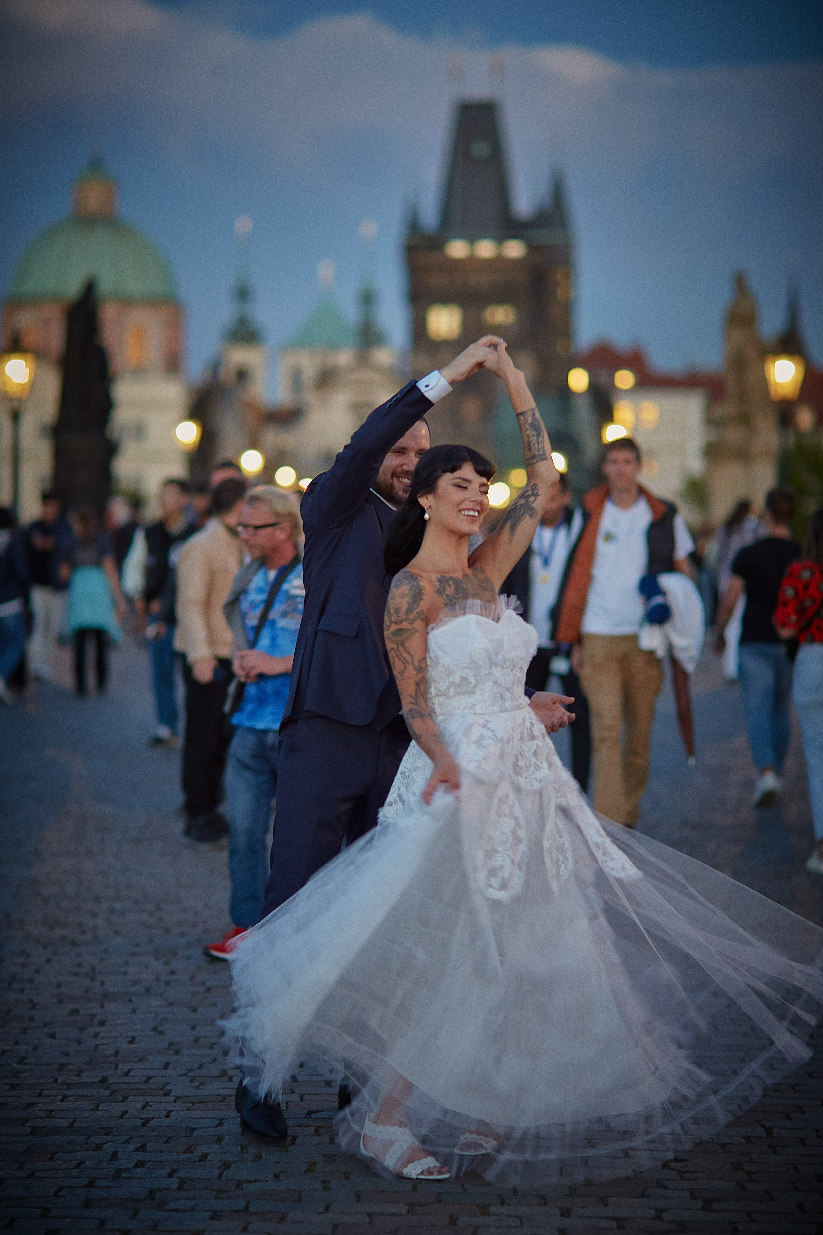 Newlyweds Dean and Courtney dance atop Charles Bridge in Prague at sunset.