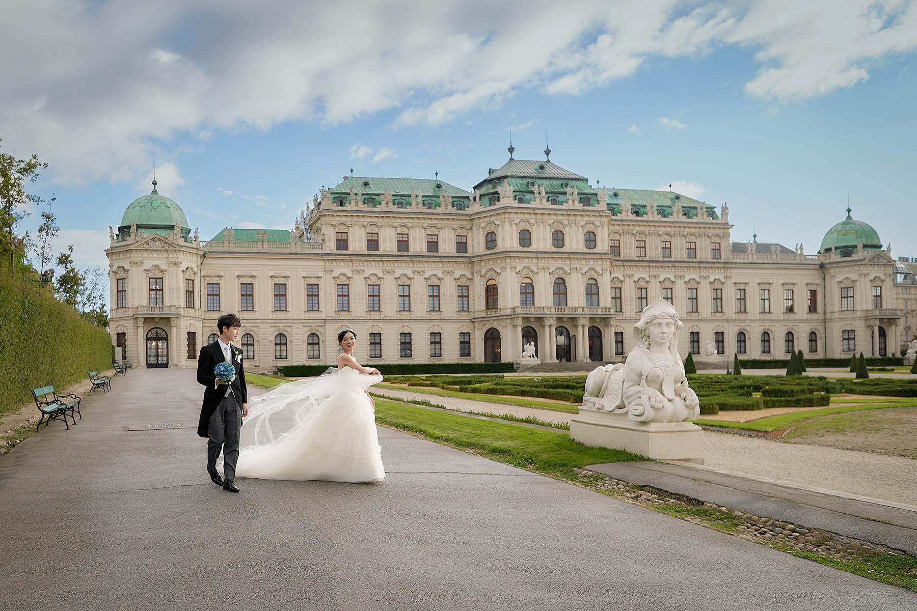 Wide view of newlyweds alone on Belvedere Palace imperial grounds.