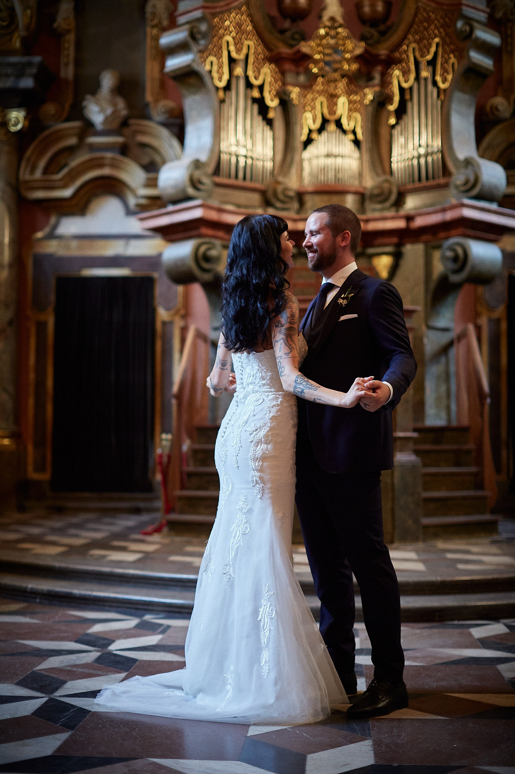 Groom inviting bride for spontaneous dance at Mirror Chapel altar.
