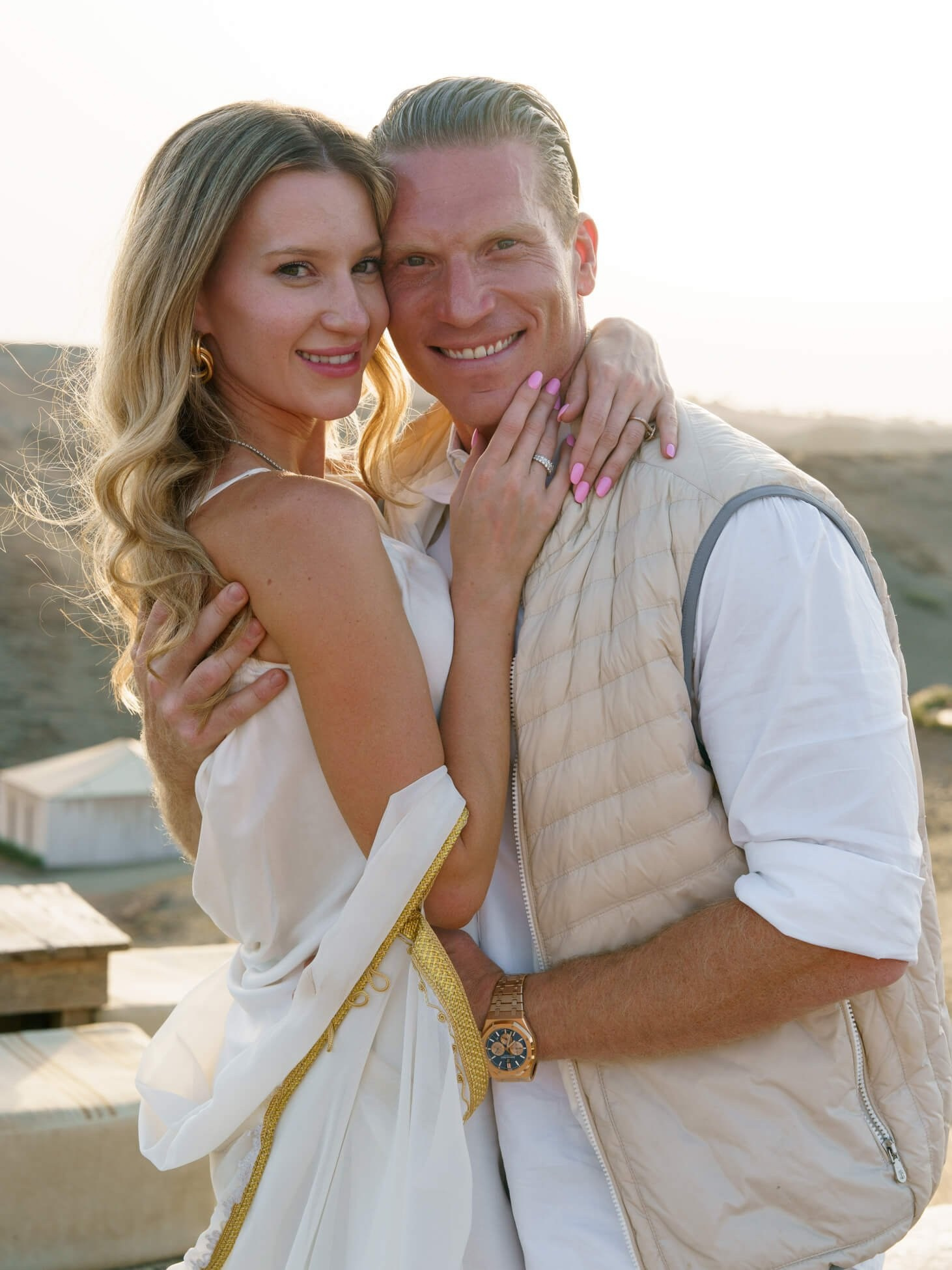 Couple embracing during luxury desert wedding portraits at sunset, Morocco