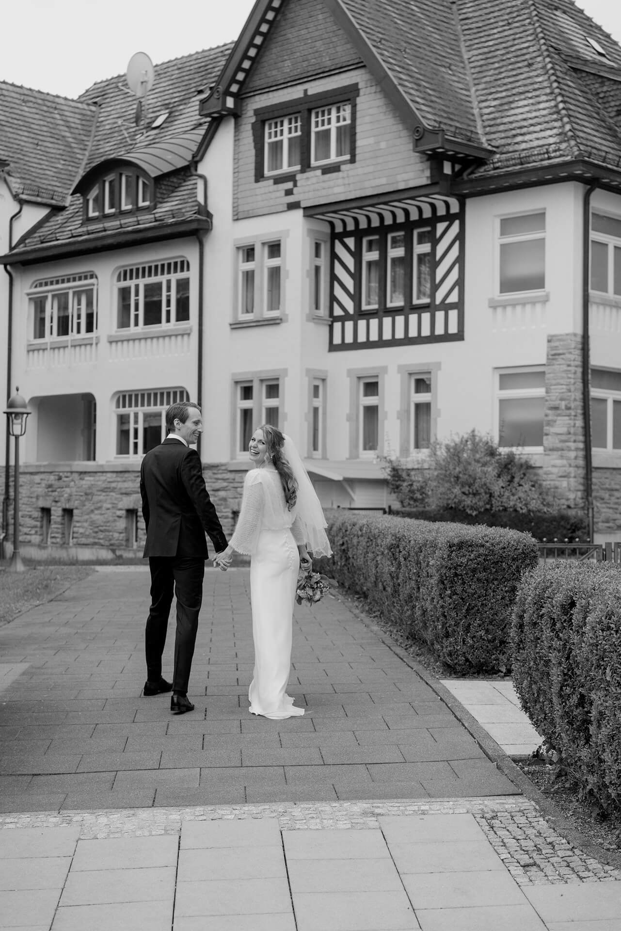 Black and white couple outside historic hotel, Falkenstein Grand wedding