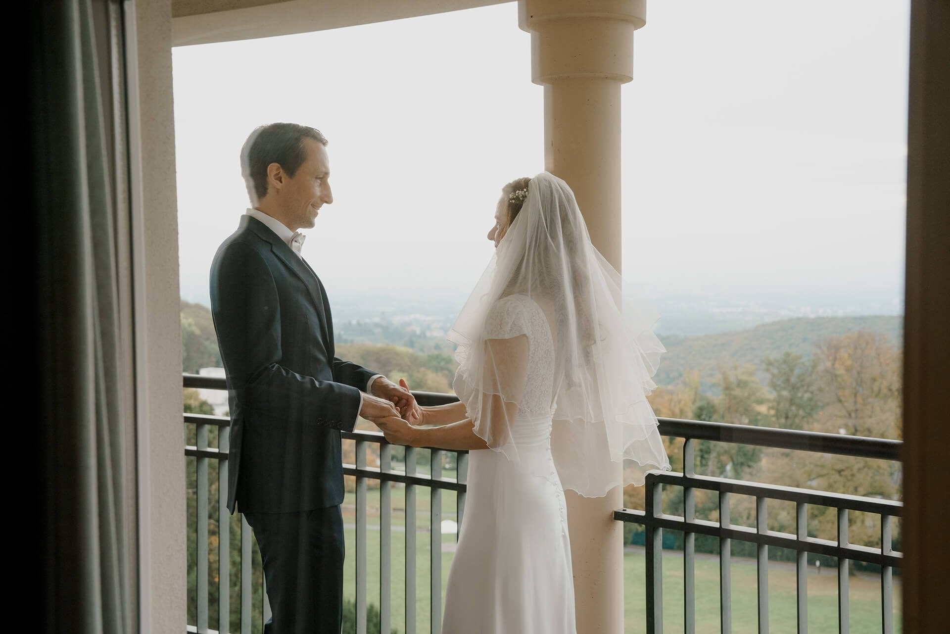 Couple exchanging rings on terrace, luxury wedding at Falkenstein Grand