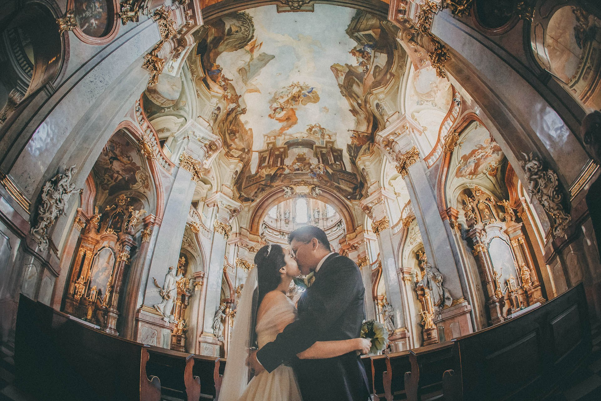 Catherine Cedric Son kiss St. Nicholas Church Prague portrait.