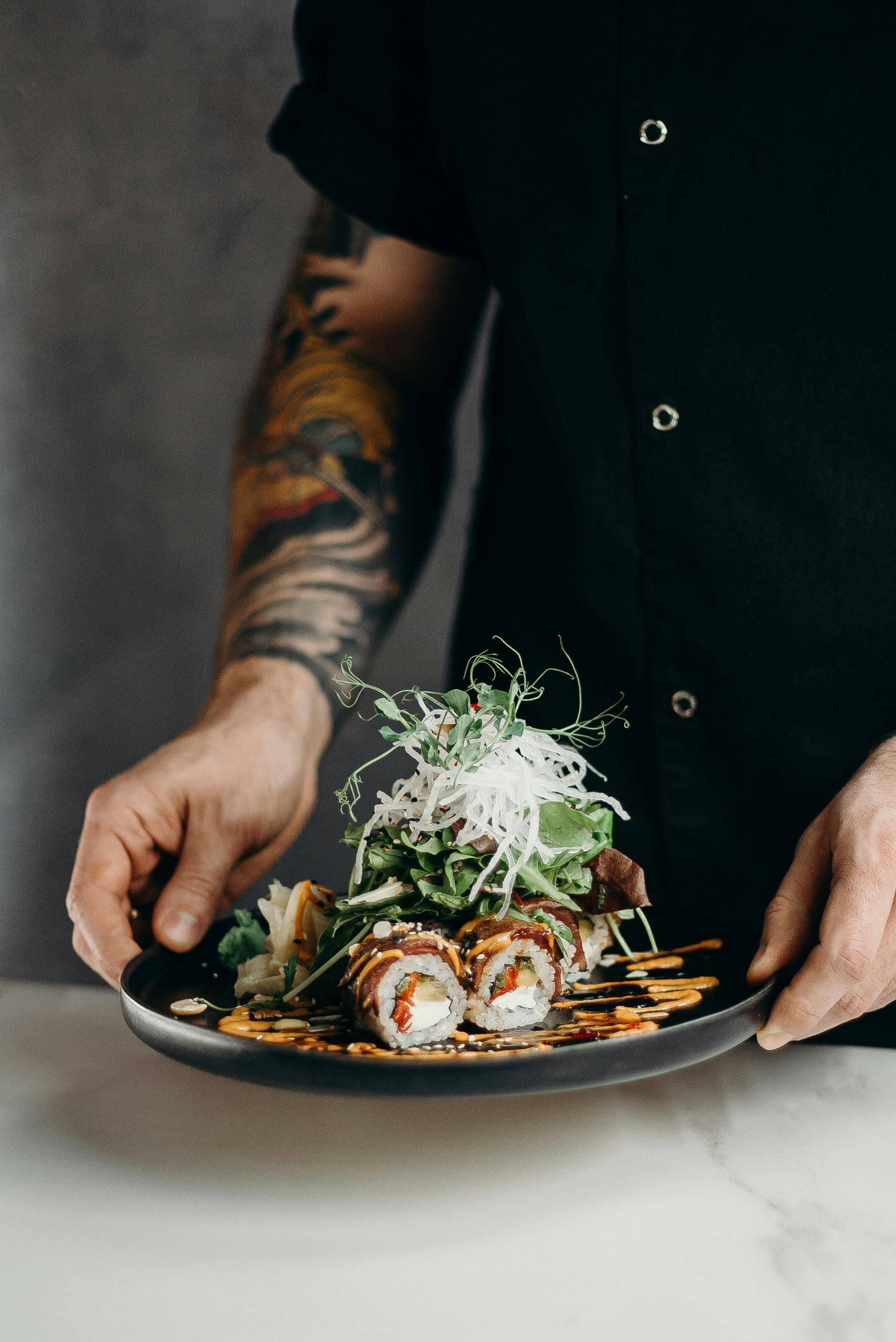 Professional food photography of chef holding plated dish, captured by London food photographer Jay Soundo.