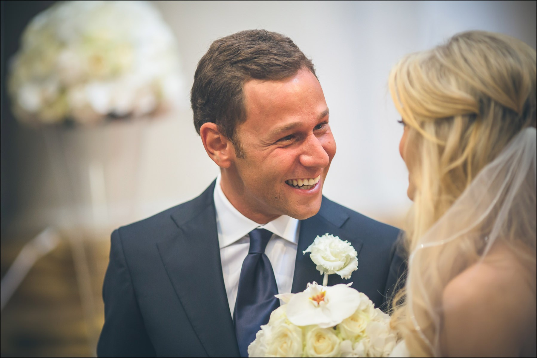 Groom gazing lovingly at bride during Prague wedding ceremony