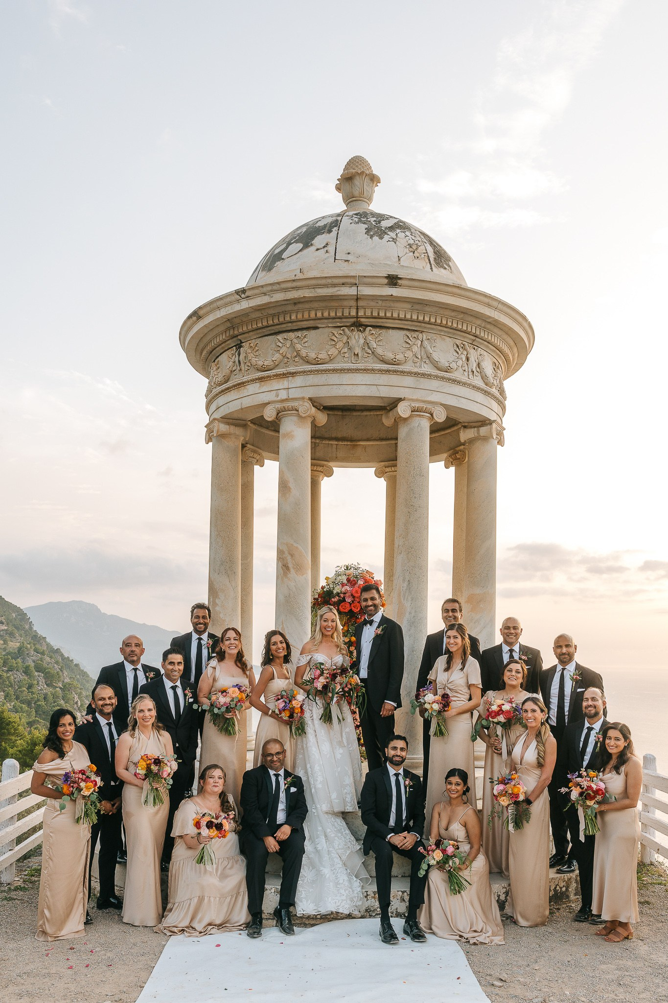 Bride, groom, and wedding party posing together at their luxury Mallorca wedding at Son Marroig