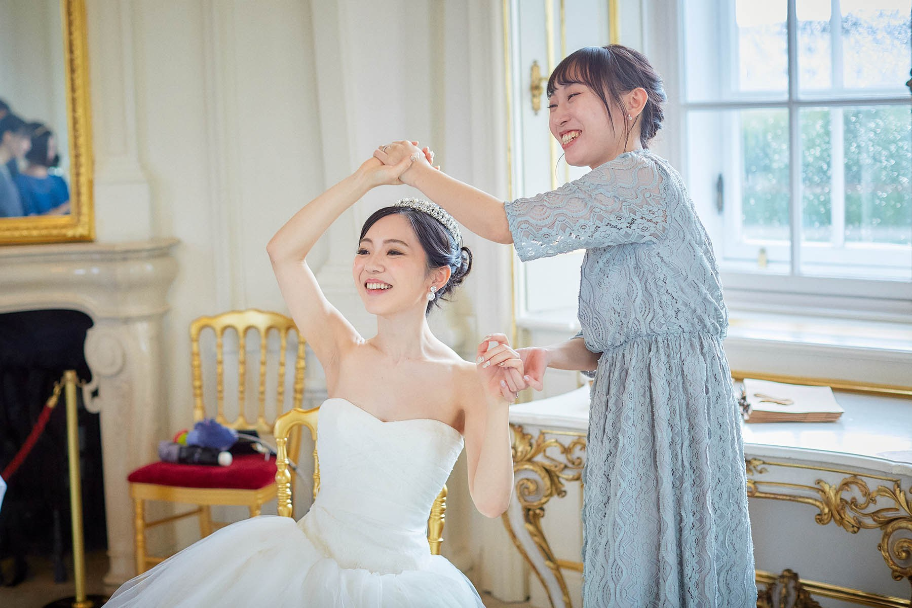 Bride laughing with friend at Belvedere Palace reception.