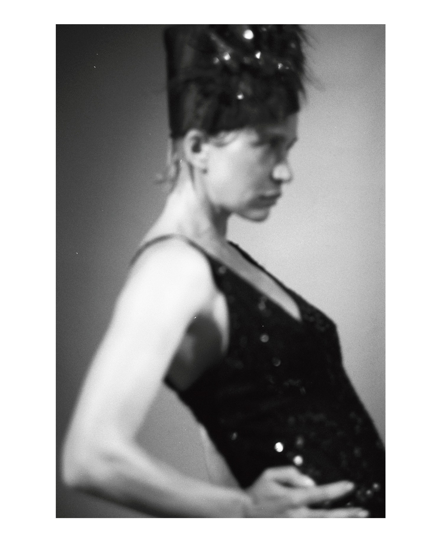 Intimate B&W film portrait in a minimalist daylight setting, authentic and raw analogue photography