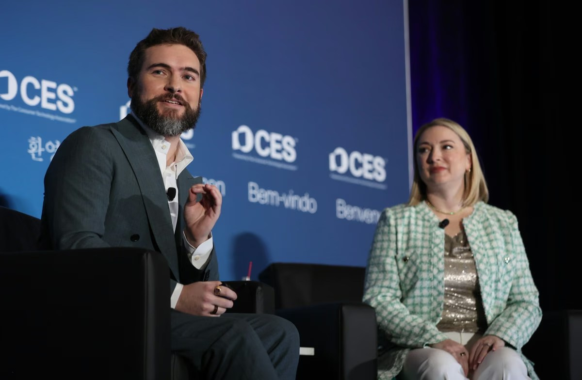 Two speakers taking part in a professionally filmed corporate panel discussion