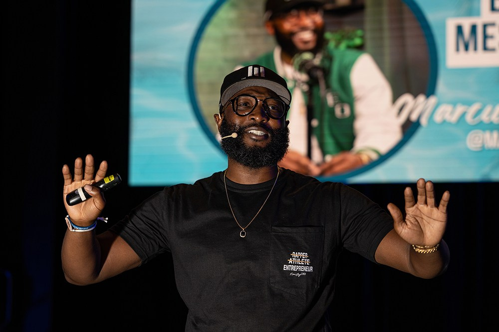 Business speaker discussing company goals during a corporate event session.