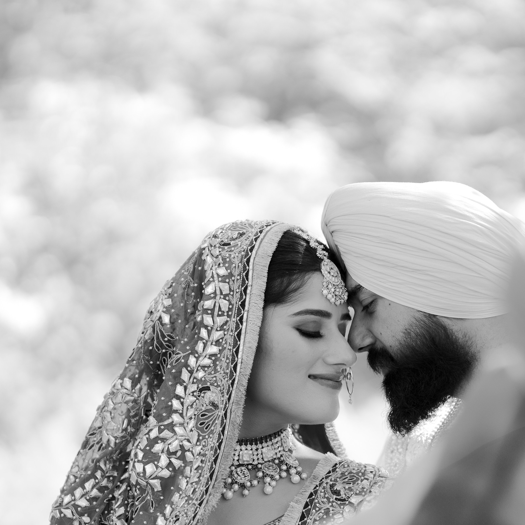 Indian bride in pink lehenga resting with eyes closed, candid bridal portrait