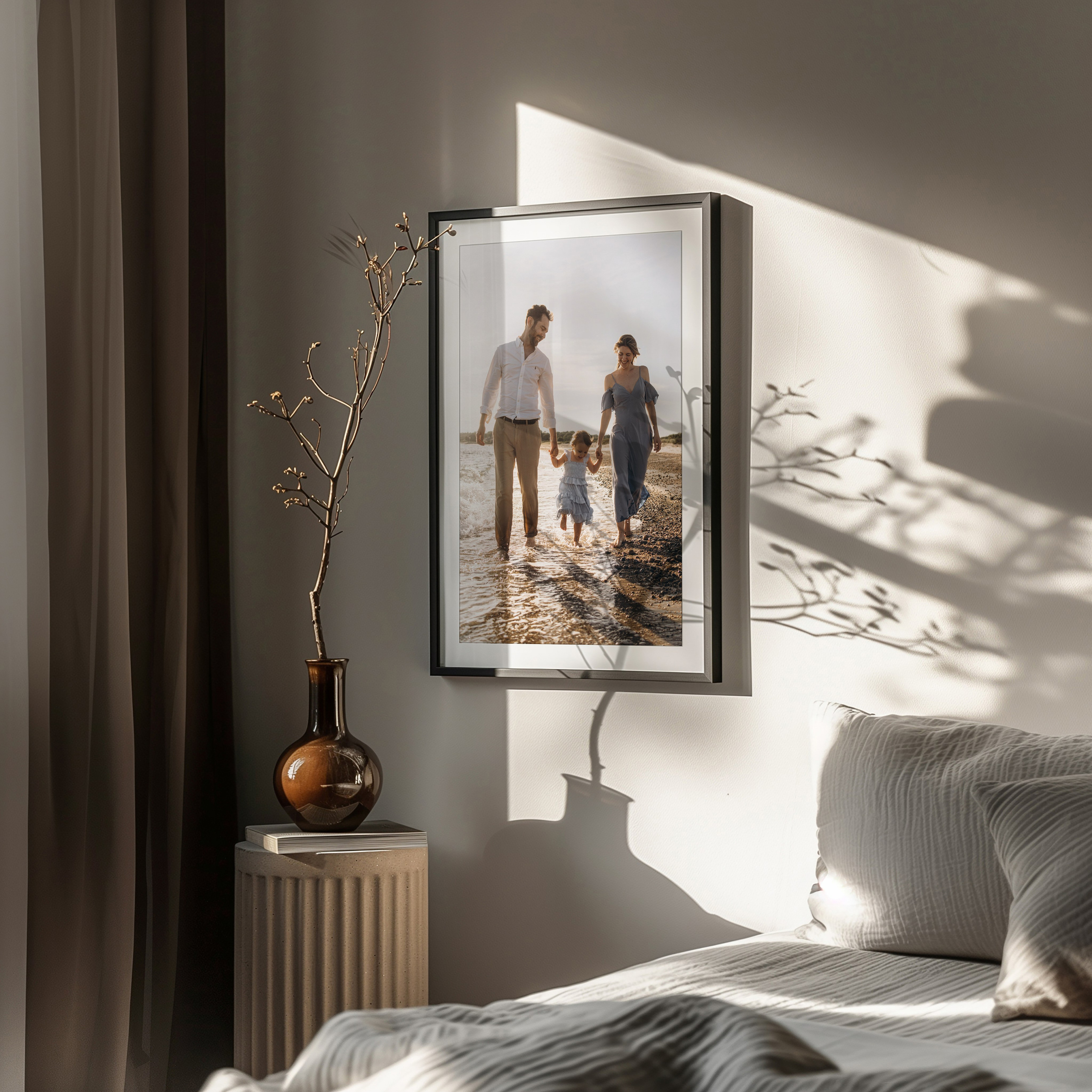 Framed portrait of a family on a sunset beach in a sunlit bedroom