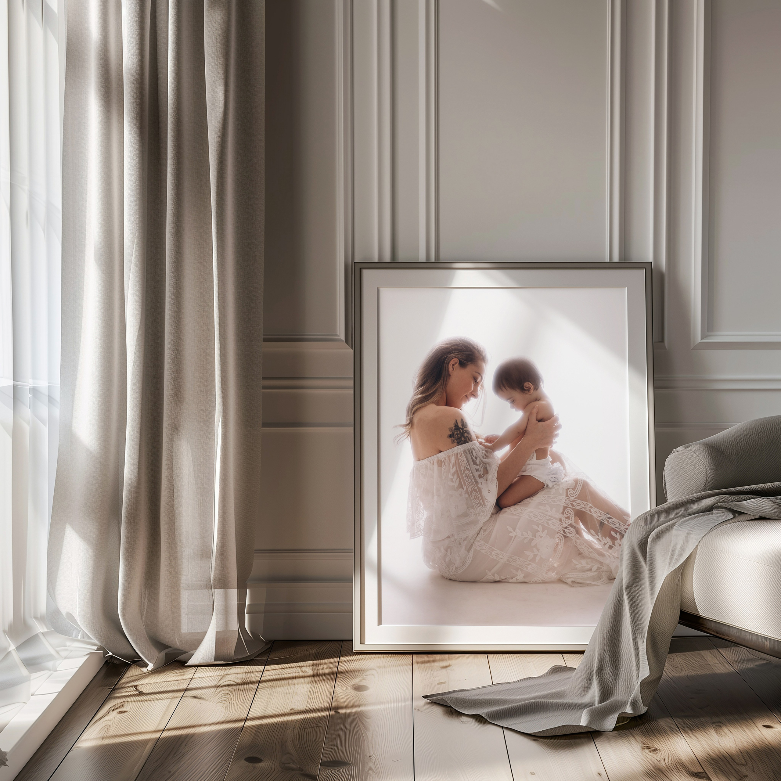 Framed portrait of a mother and baby leaning in a sunlit room