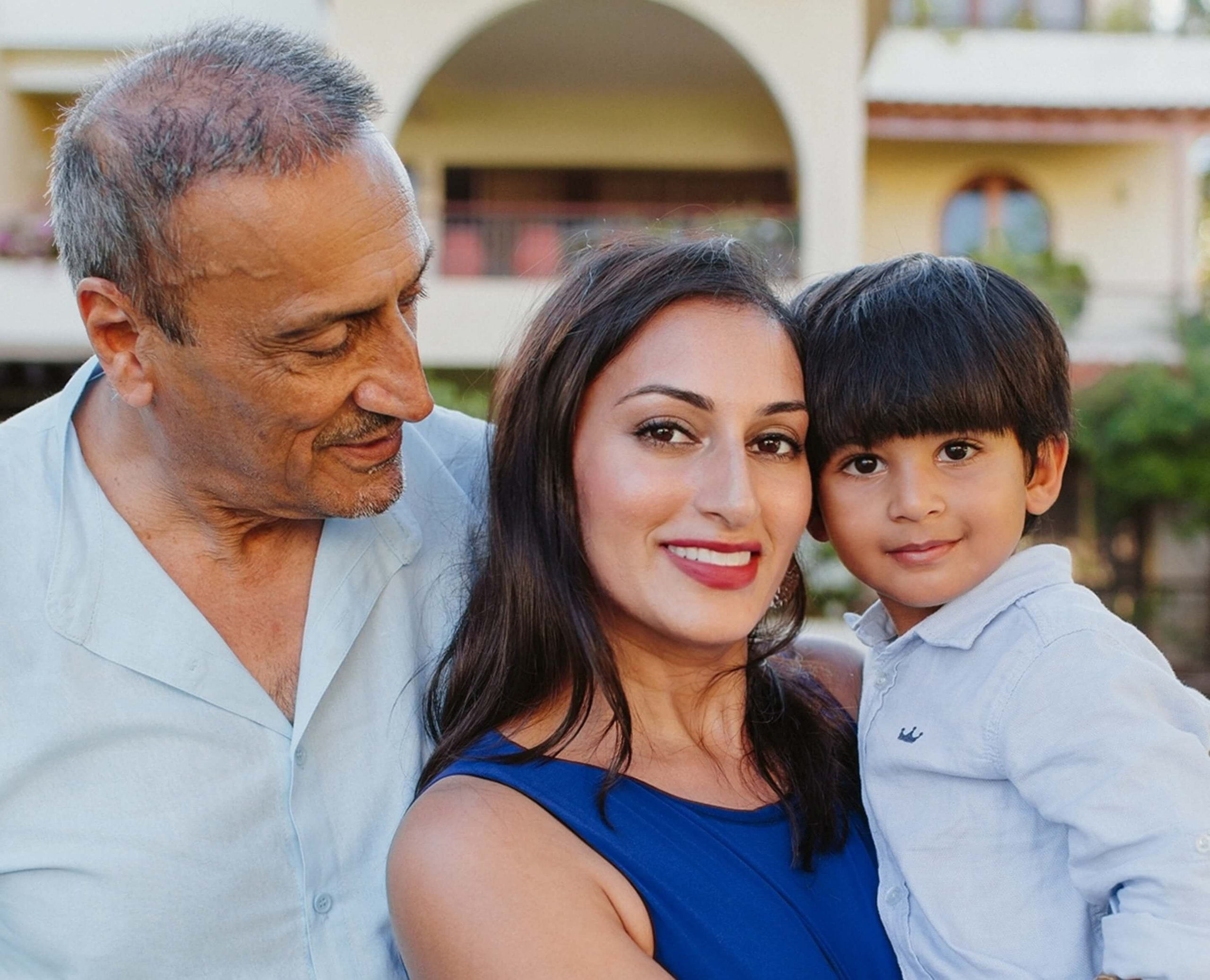 Joyful group portrait capturing three generations of one family during an elegant photo session in Mombasa, Kenya.
