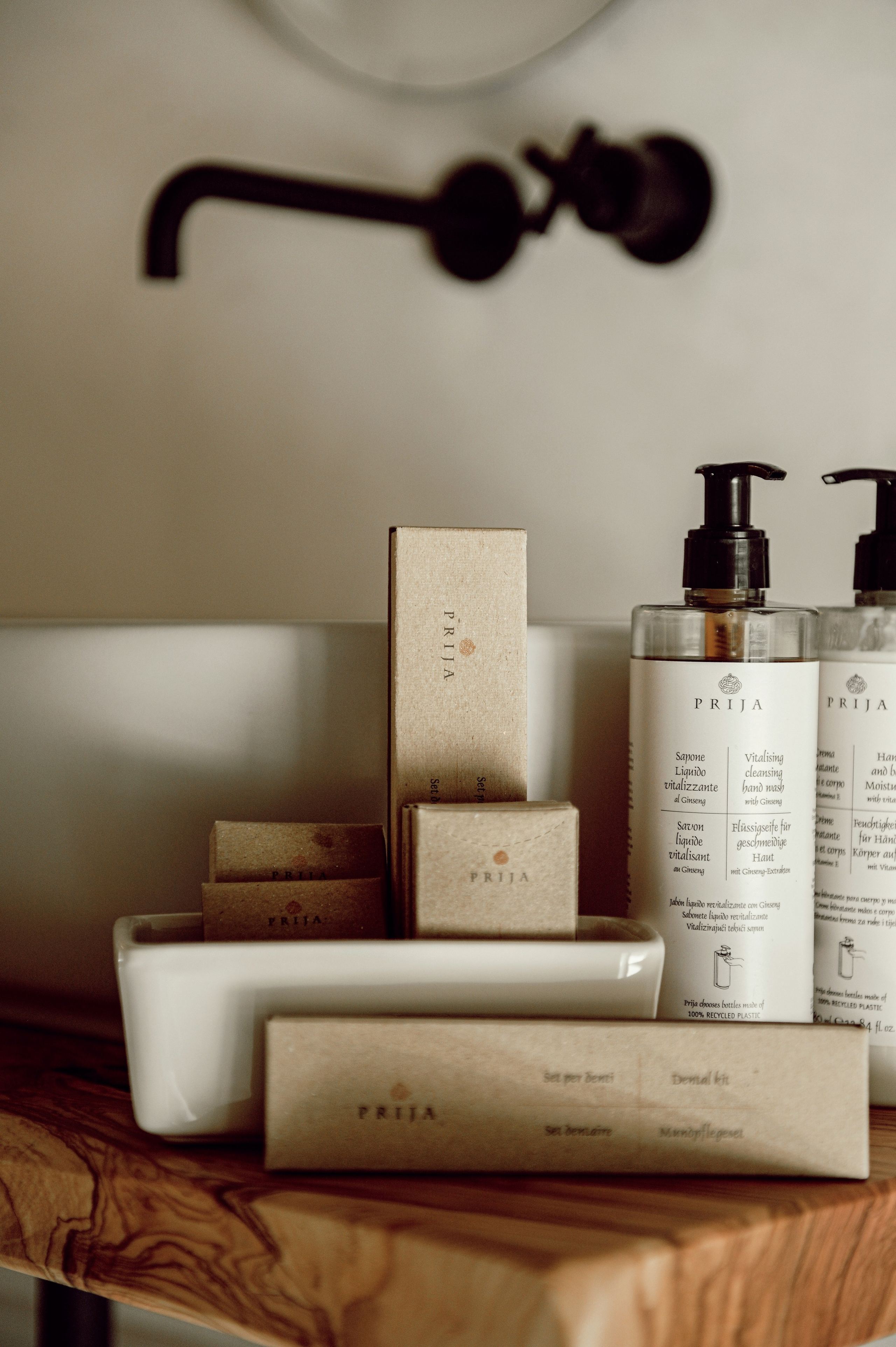 Eco-friendly hotel toiletries in a rustic bathroom in Puglia, arranged on a wooden counter with soft natural light — perfect for boutique accommodations and vacation homes.