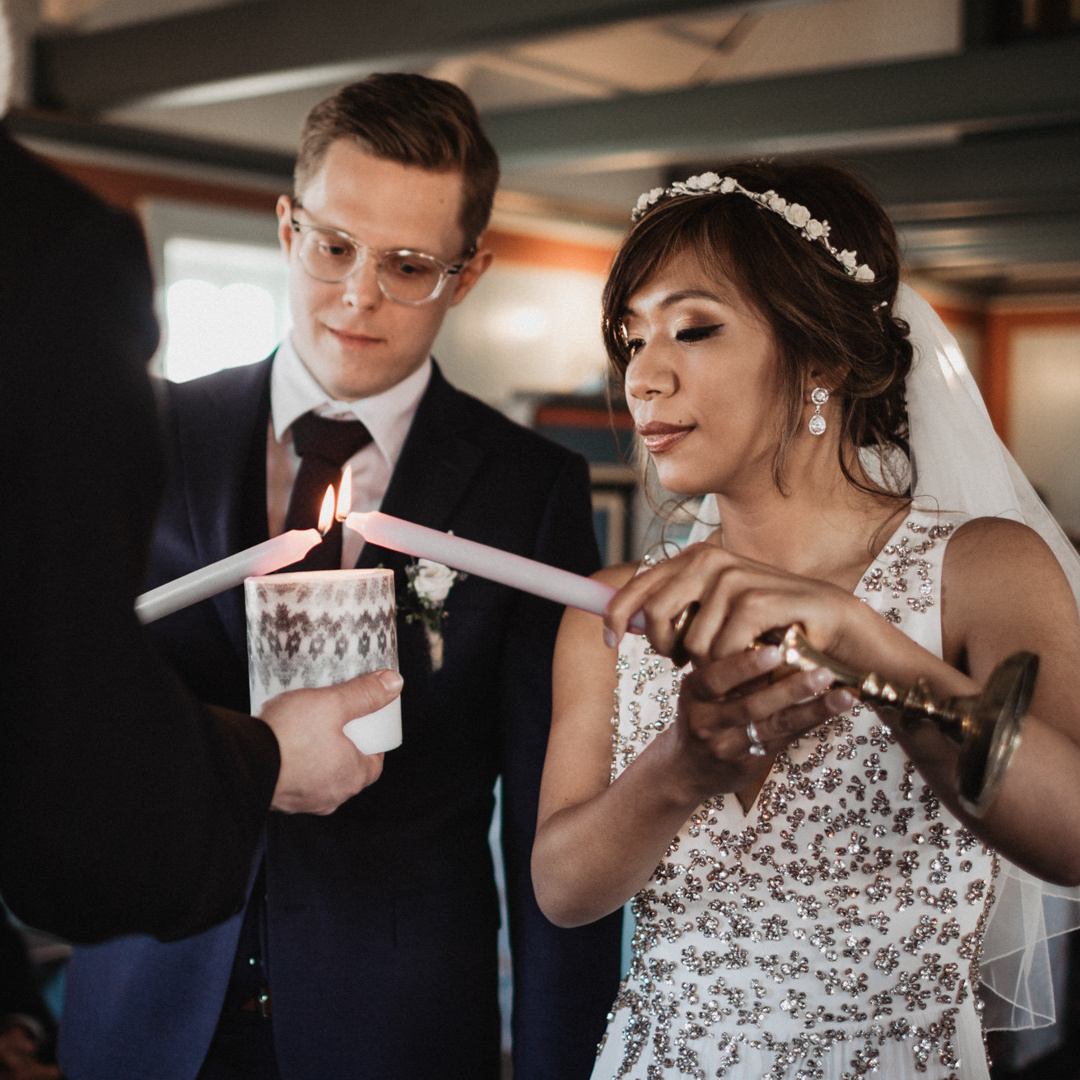 A couple with candles on their wedding day in icelandic black church 