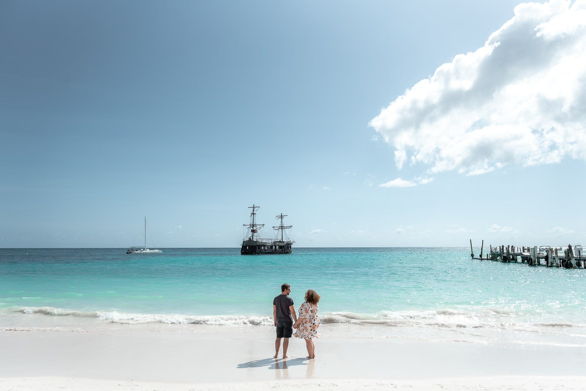 Romantic couple embracing on a white sand beach during a Punta Cana love story photoshoot at sunset.