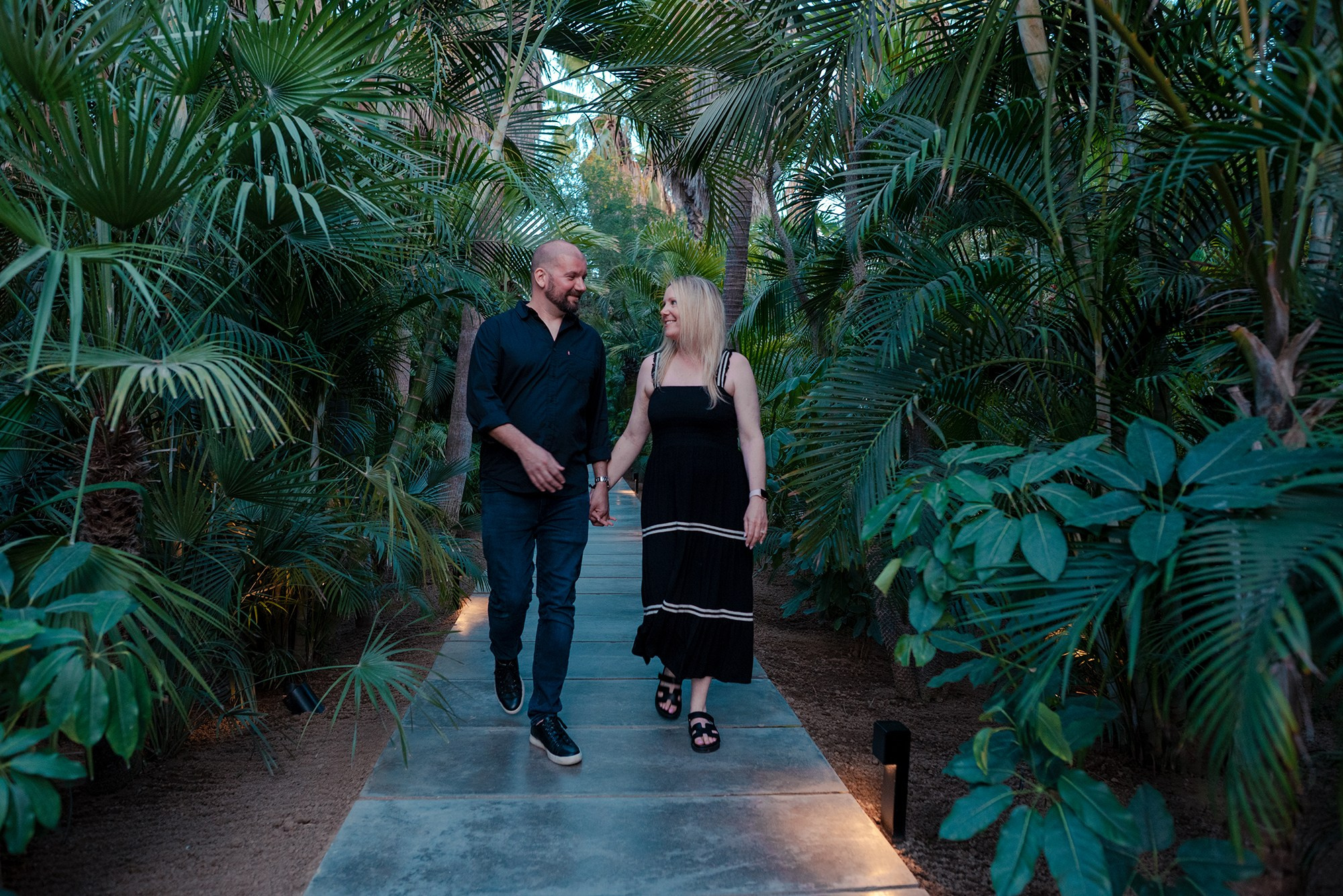 Sean and Lisa walking hand in hand through Acre Restaurant entrance San José del Cabo Los Cabos Mexico
