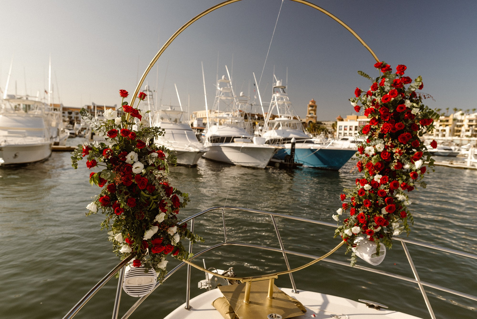 Floral arch decoration on a yacht dock for a Cabo San Lucas proposal