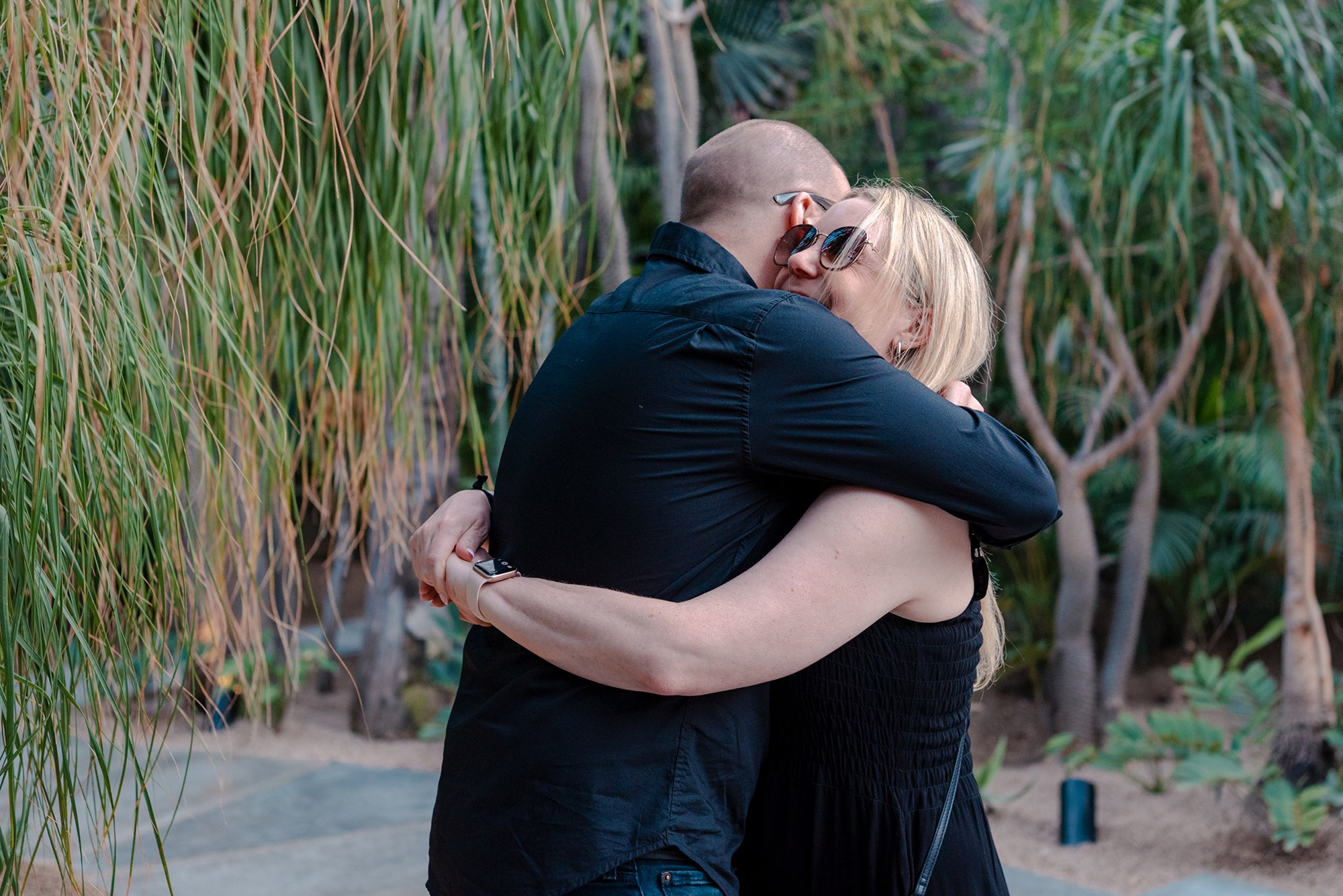 Newly engaged couple embracing after surprise proposal at Acre Restaurant Los Cabos Mexico