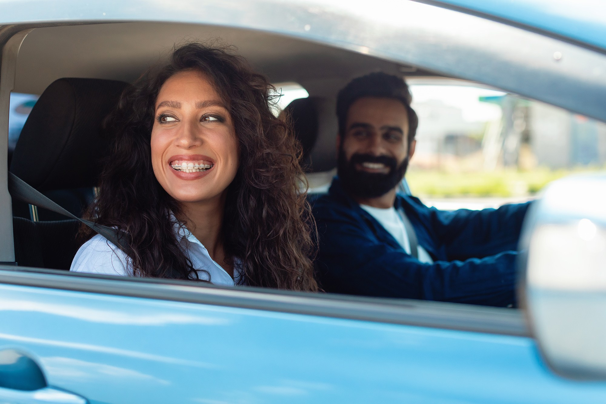 Couple in a rental car, symbolizing freedom and exploration for self-drive tours around Athens and Attica.