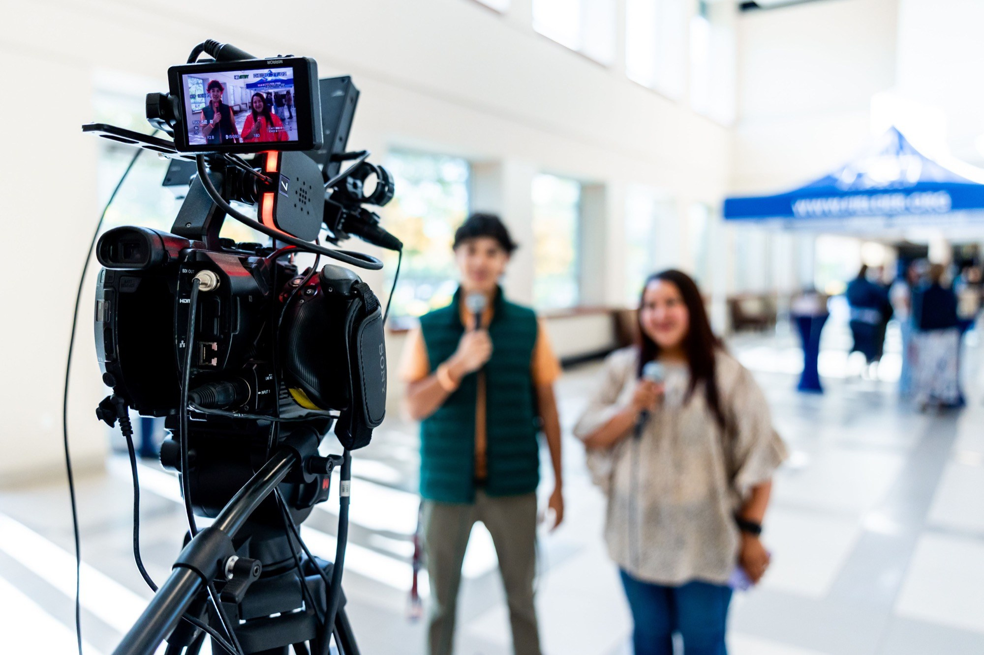 Professional camera setup recording two participants during a business video interview