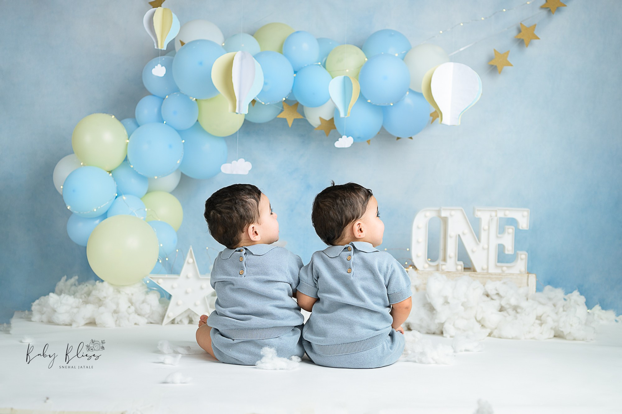 twins baby boy in light blue colour outfit seating together for cake smash photo shoot