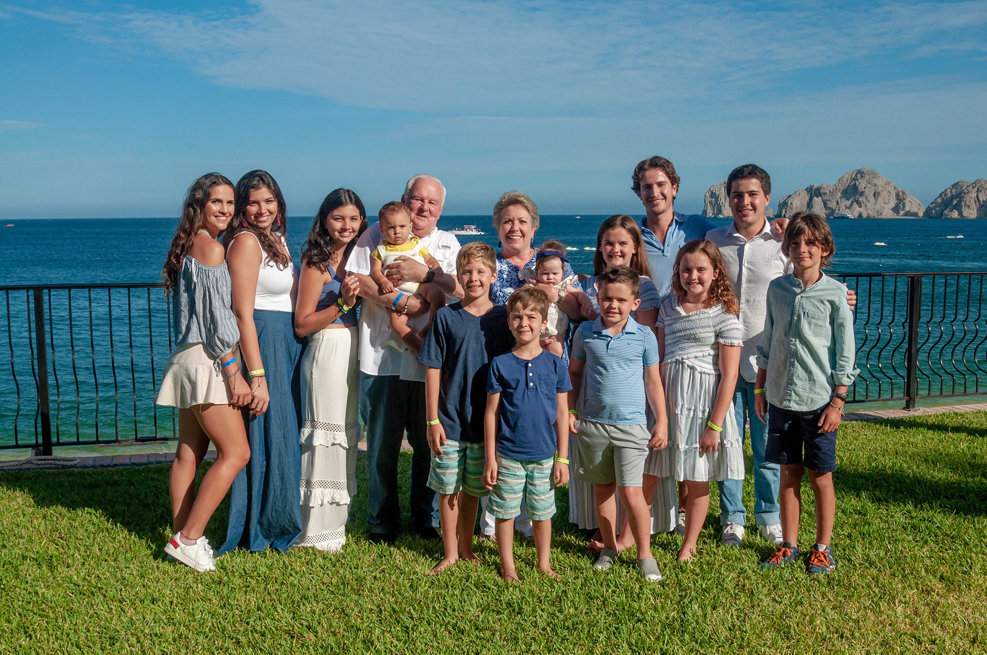 Large family on a Cabo beach dressed in a blue, white, and denim color palette