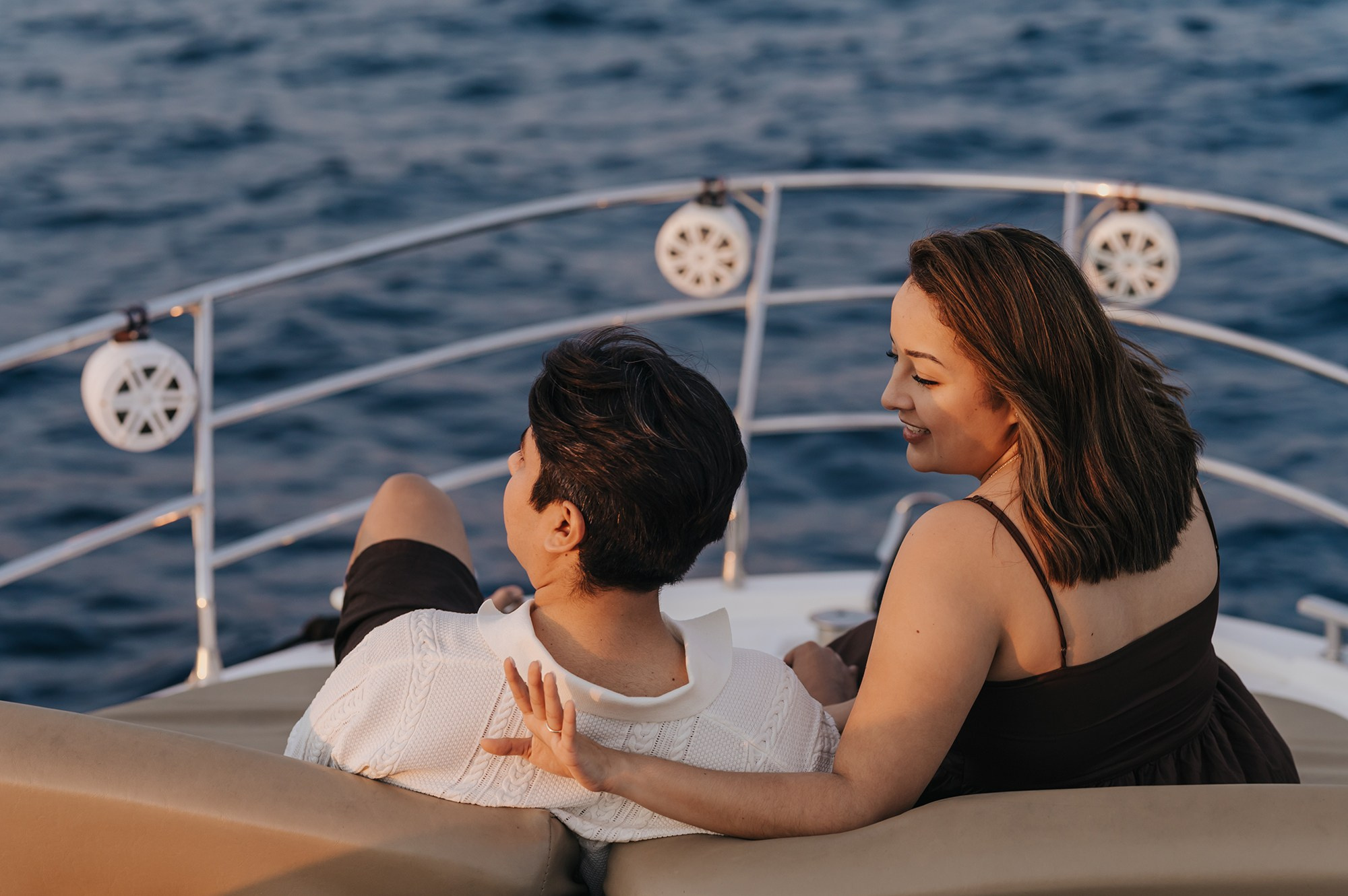 Newly engaged couple embracing at sunset on a yacht in Cabo San Lucas