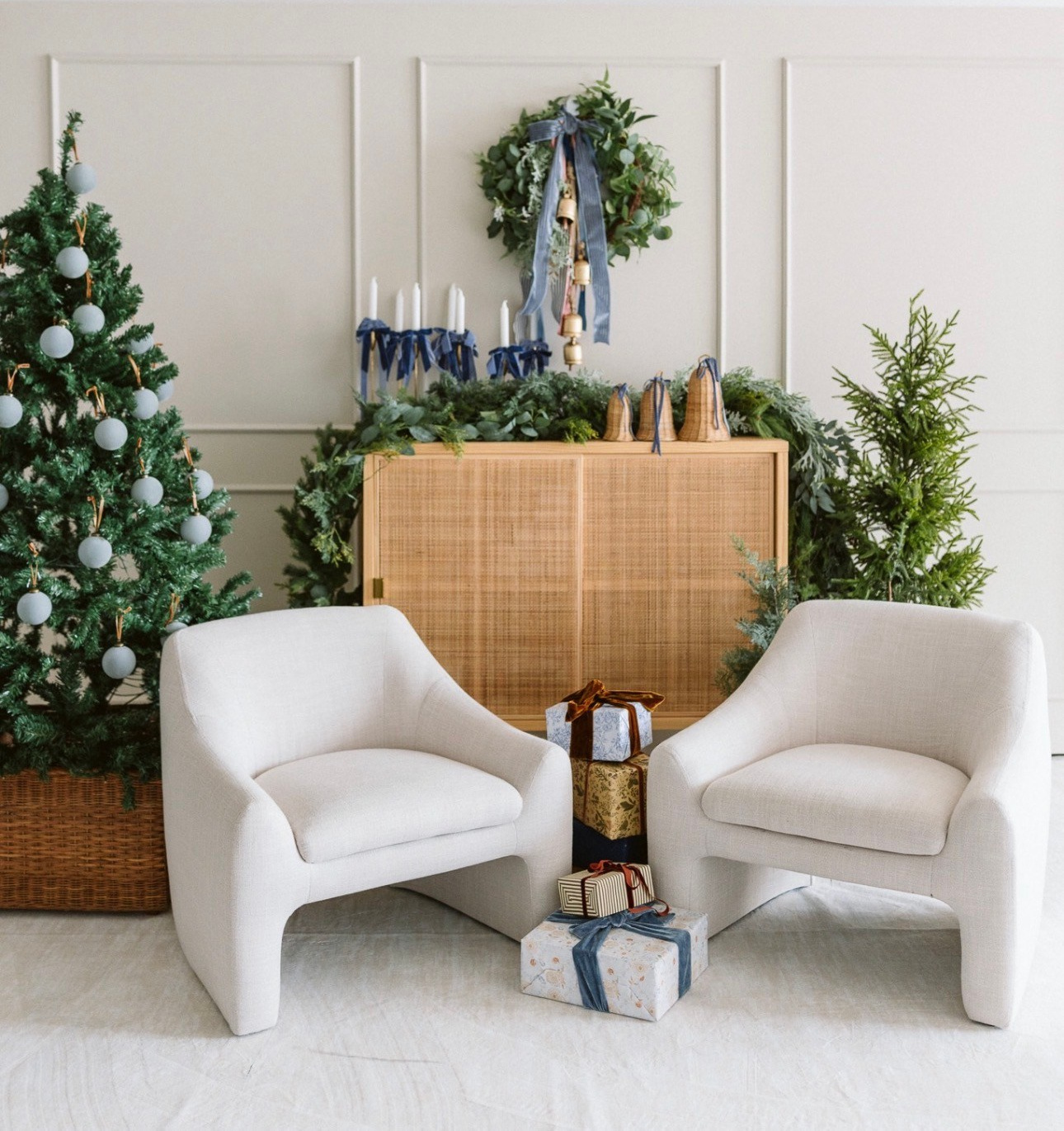 Minimal Christmas studio setup with neutral décor and evergreen trees