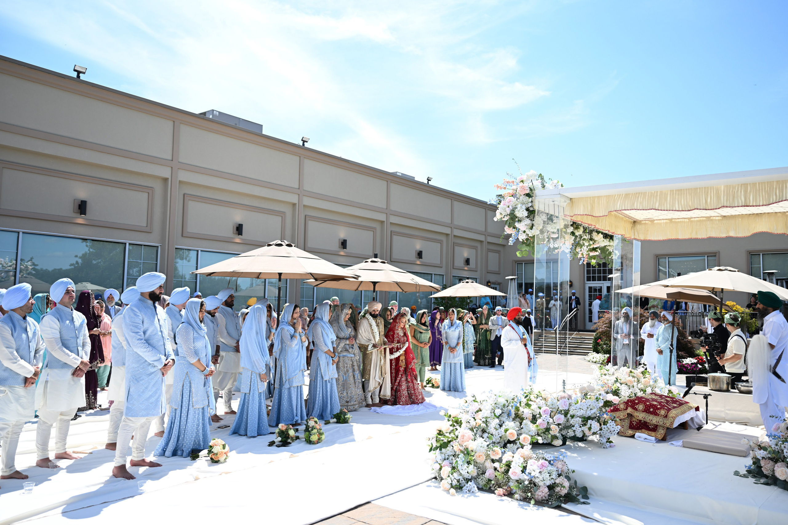 a group of people standing around a wedding ceremony