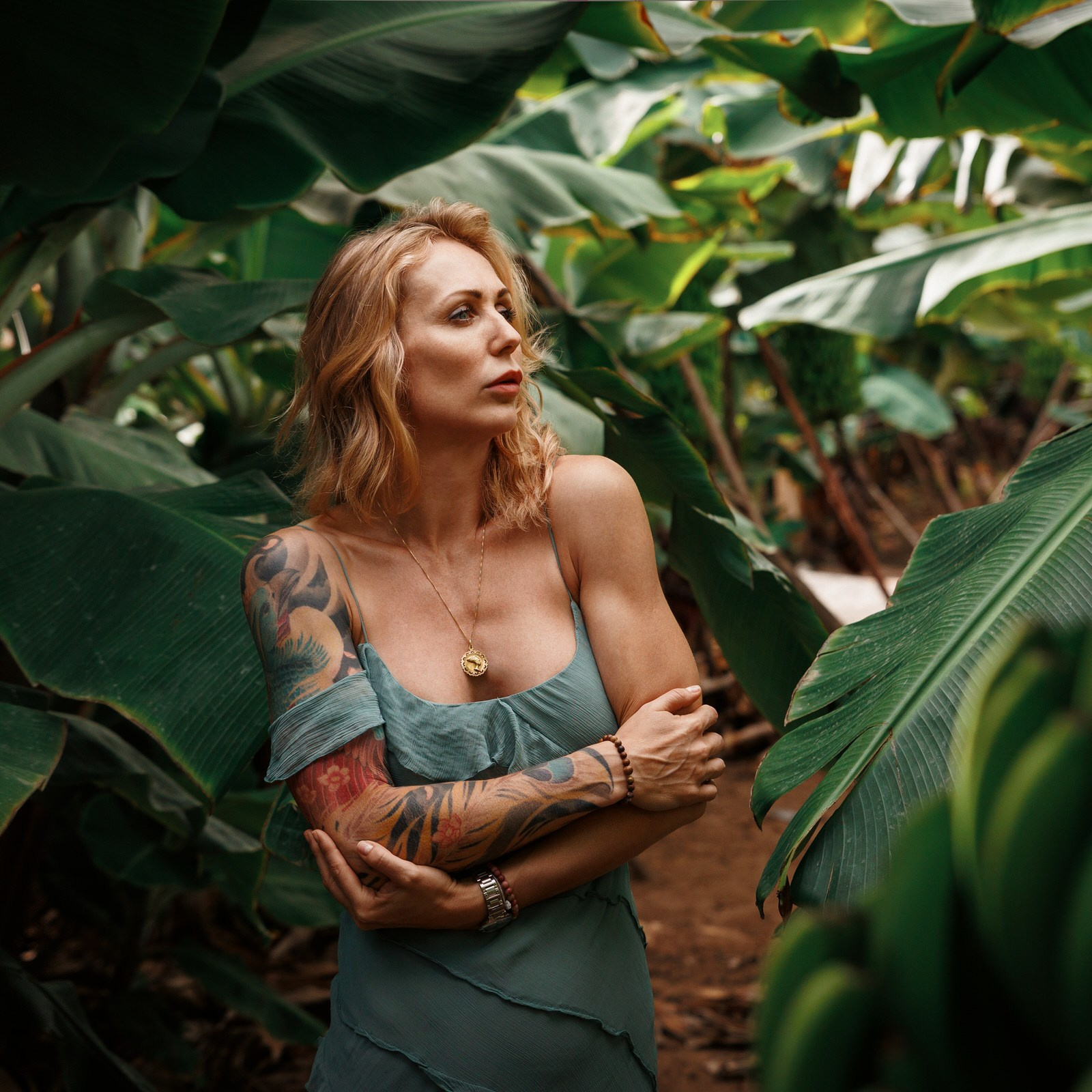 Vibrant solo traveler portrait in Arucas Banana Plantation surrounded by lush banana leaves