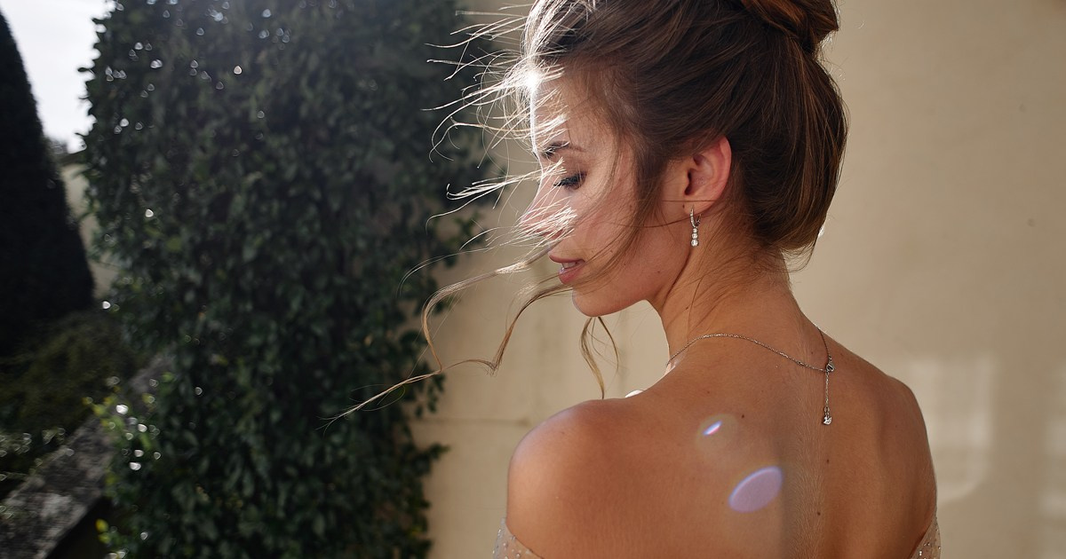 Bride in open back wedding dress — golden hour bridal portrait by Bella Vita Weddings