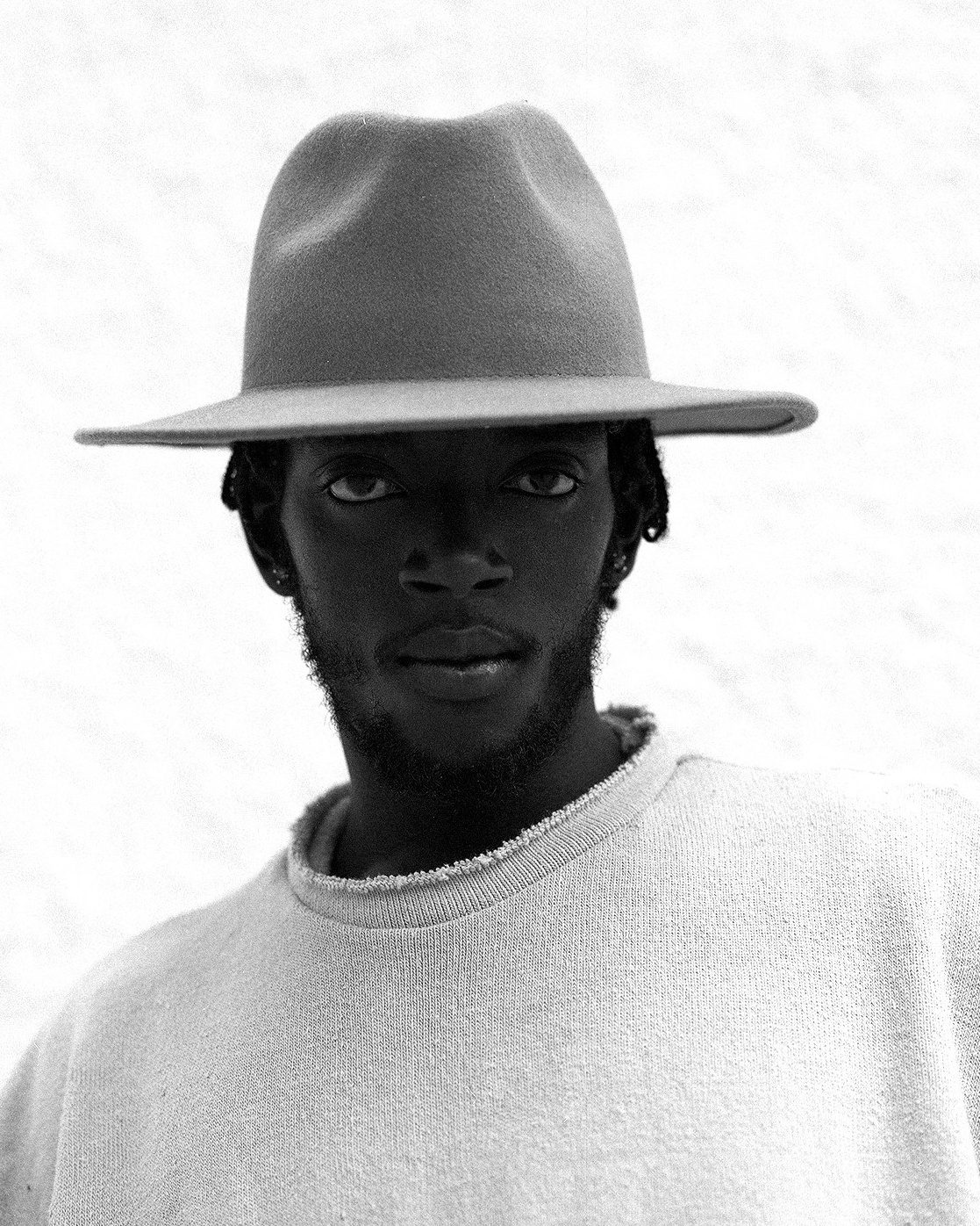 Black and White photo portrait of a man in hat. Camera Mamiya RZ67. Shot on film.