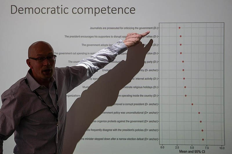 Charles University lecturer discussing democratic competencies across various areas during a classroom discussion in Prague, Czech Republic — Kurt Vinion Corporate Photography