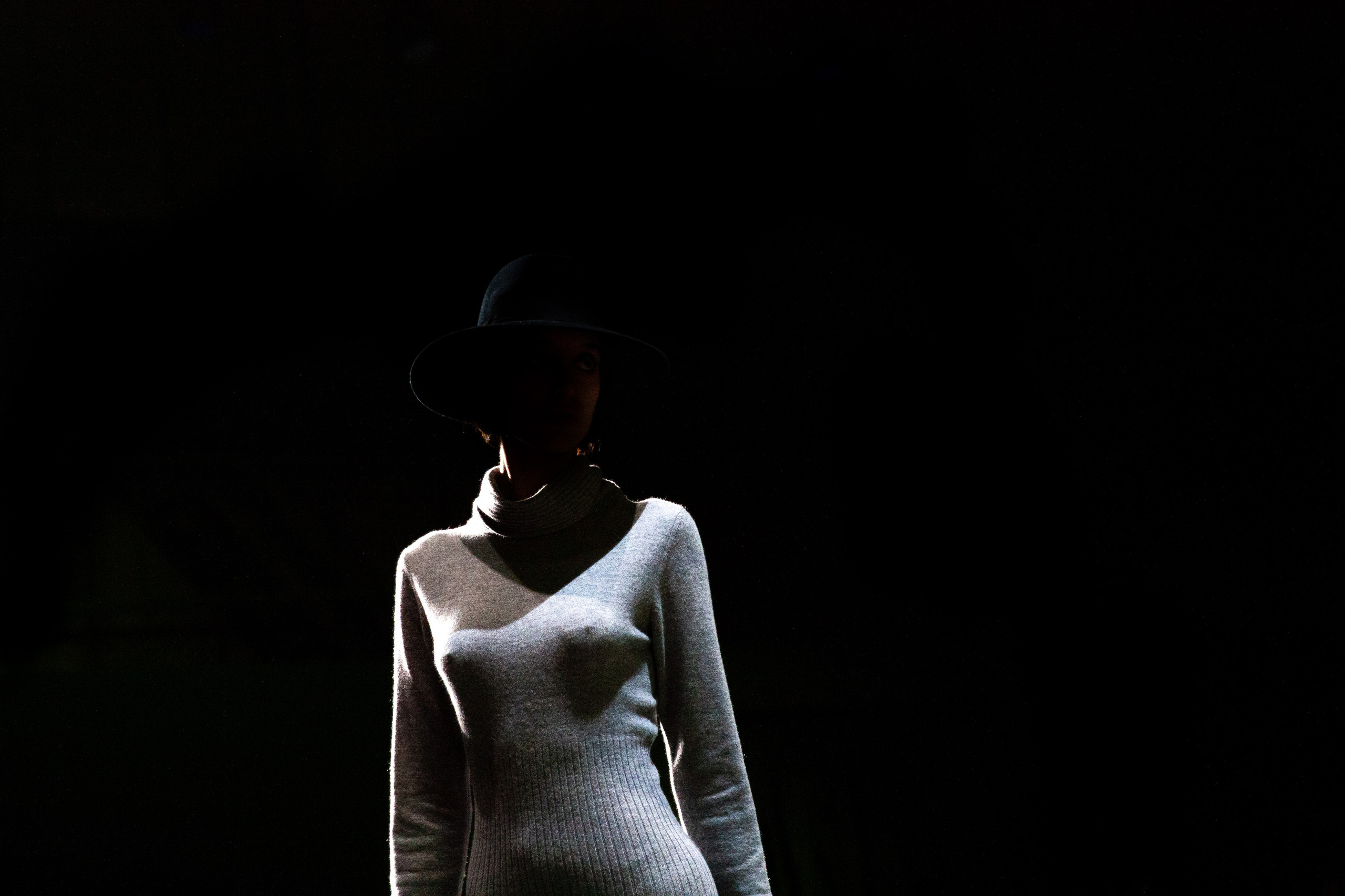 An editorial fashion shot from Rome Fashion Week, highlighting movement and contrast.